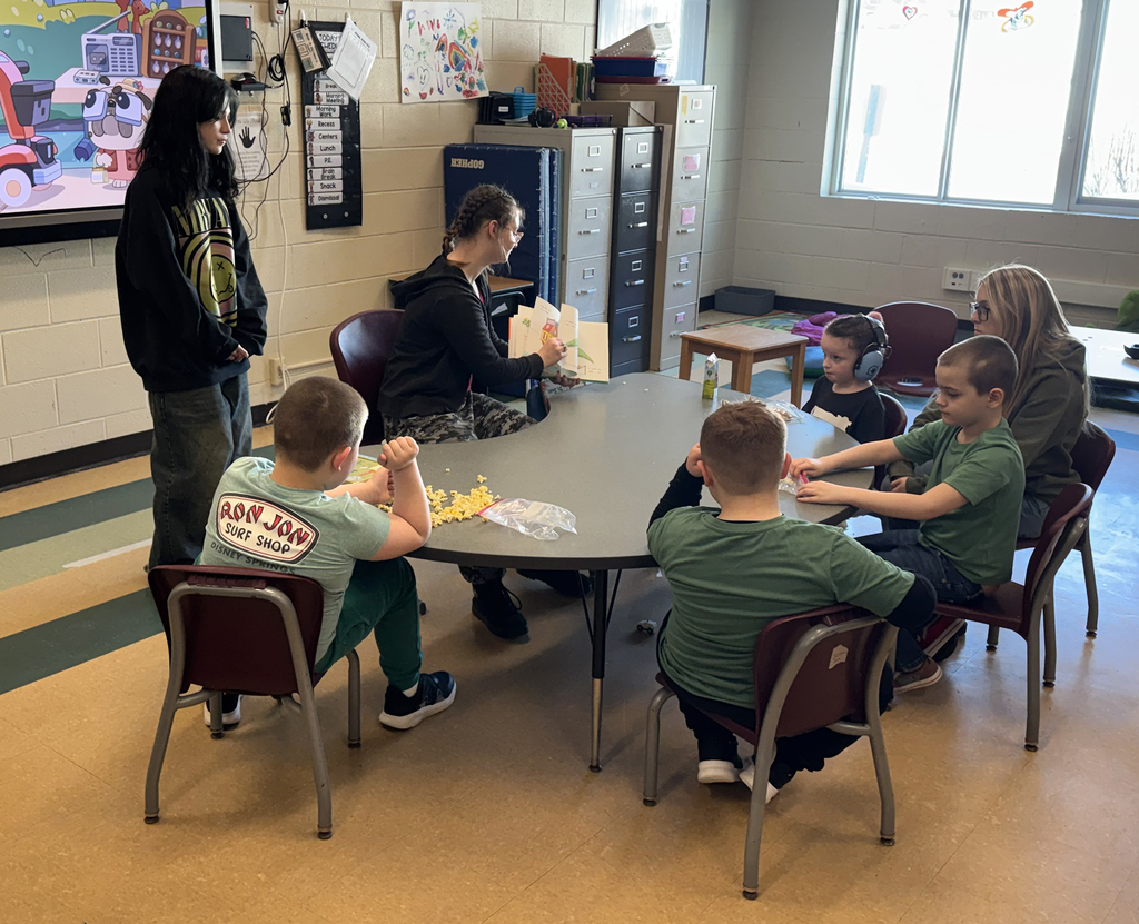 student reading a Dr. Seuss book to others