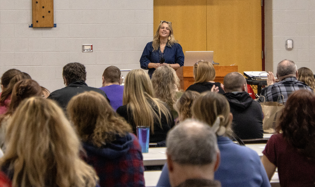 Sara Stafford at lectern, smiling