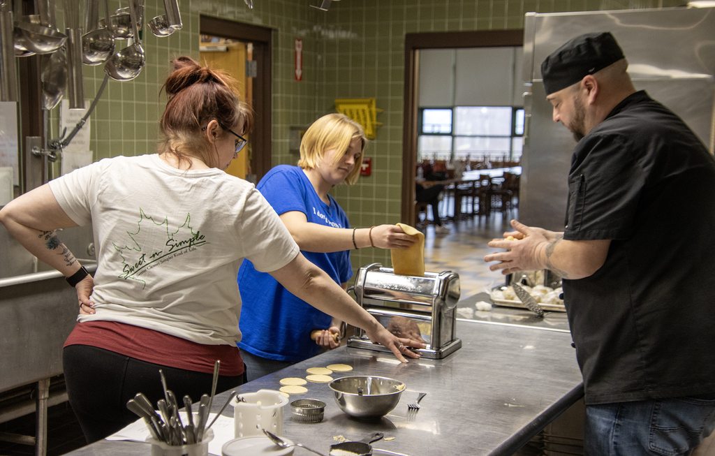 3 people making pierogies