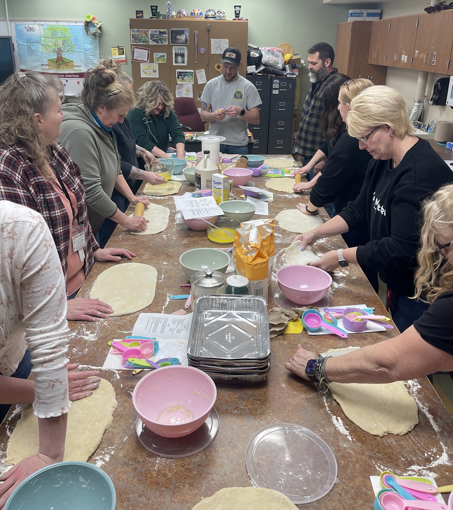 staff members make cinnamon buns in classroom