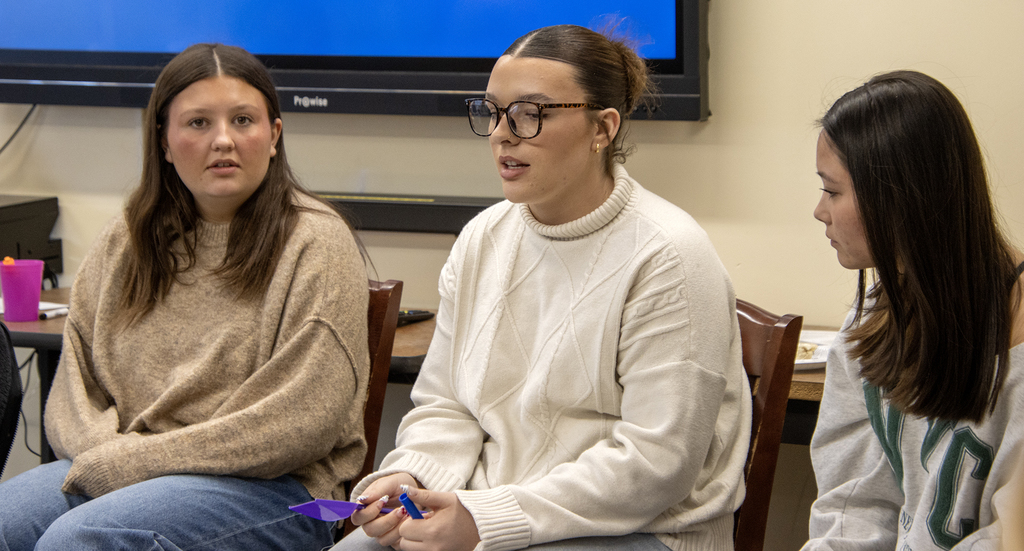 3 students in a talking circle