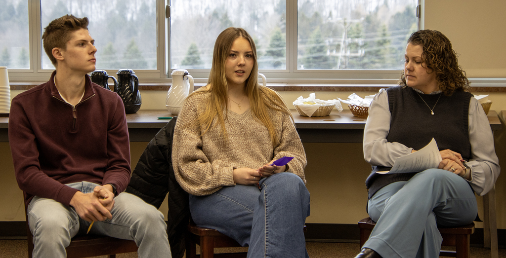 2 students and an adult in a talking circle