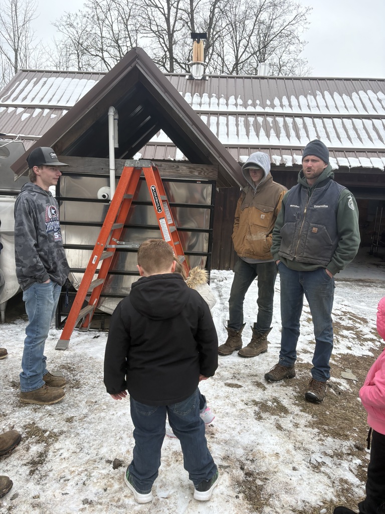 Teacher and two CTE students speak to visitng group