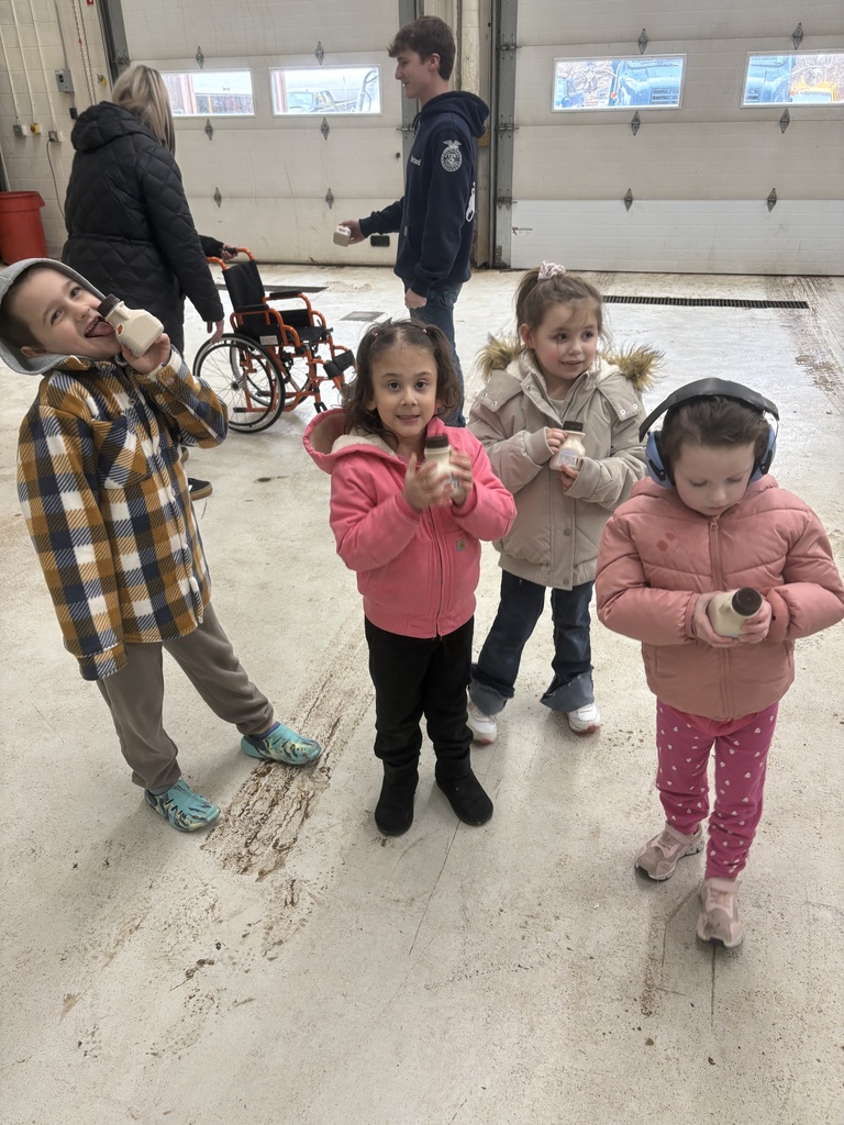 small children holding maple syrup