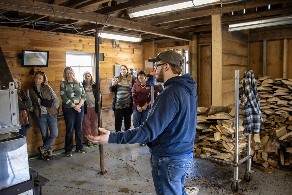 Conservastion student explains evaporator to SSC staff