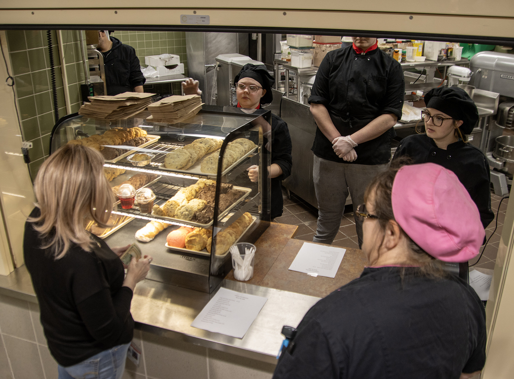 SSC staff at bake shop window
