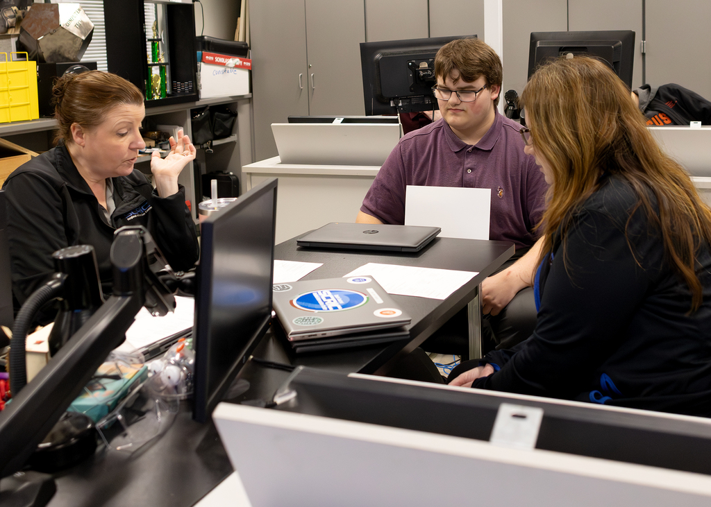recruiter speaks with two students