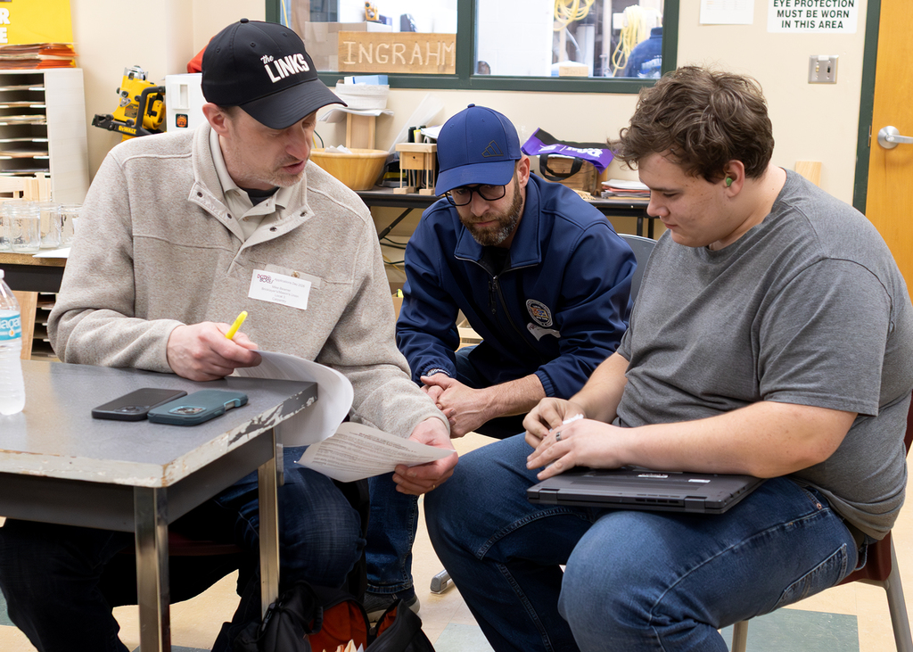 two union reps speak with a student
