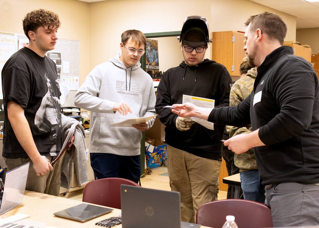 3 students speak with a trade union rep