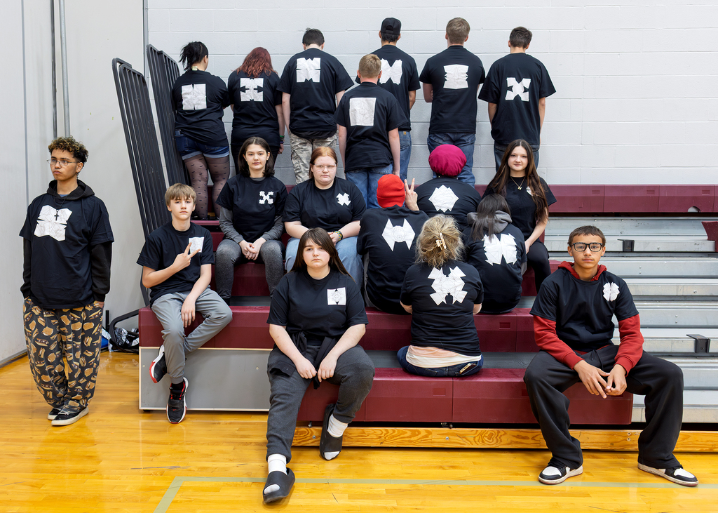 students wearing quadratic equation design shirts