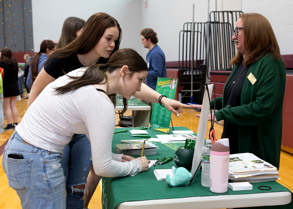 2 students and a recruiter at the college & career fair