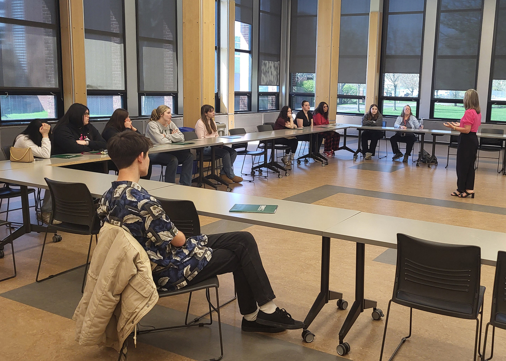 Nurse assisting students listen to an MVCC presenter