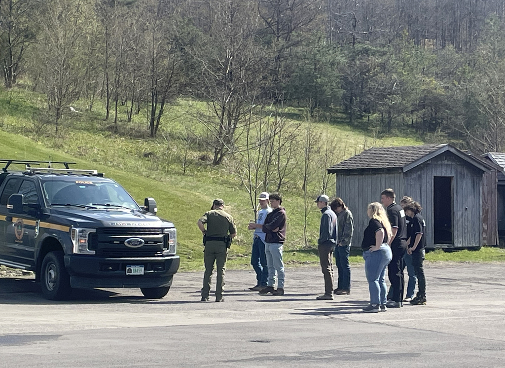 Forest Ranger speaks with students next to his truck