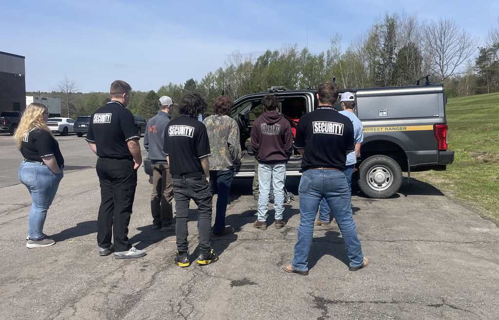 Forest Ranger speaks with students next to his truck