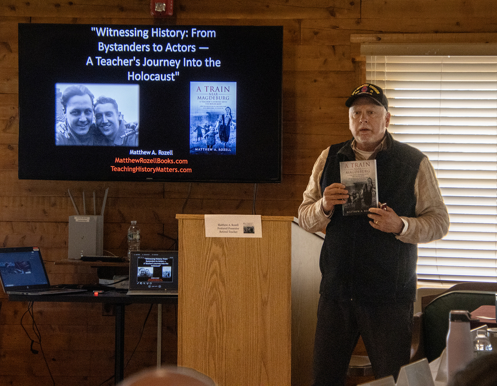 Matt Rozell holds his book
