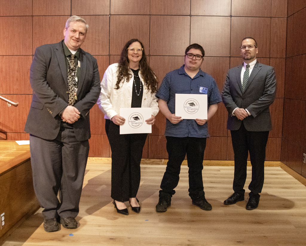 DCMO BOCES Pole Campu Principal Ryan DeMars, teacher Ann French, student Matthew Mackay, and District Superintendent Michael Rullo pose with two certificates.