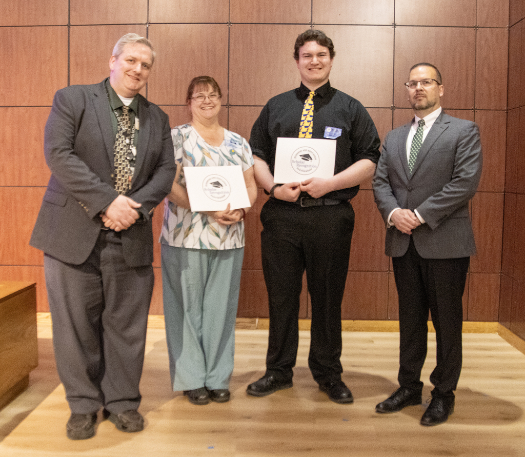 DCMO BOCES Pole Campu Principal Ryan DeMars, teacherJeanni Romanowski, student Pierce Haney, and District Superintendent Michael Rullo pose with two certificates.