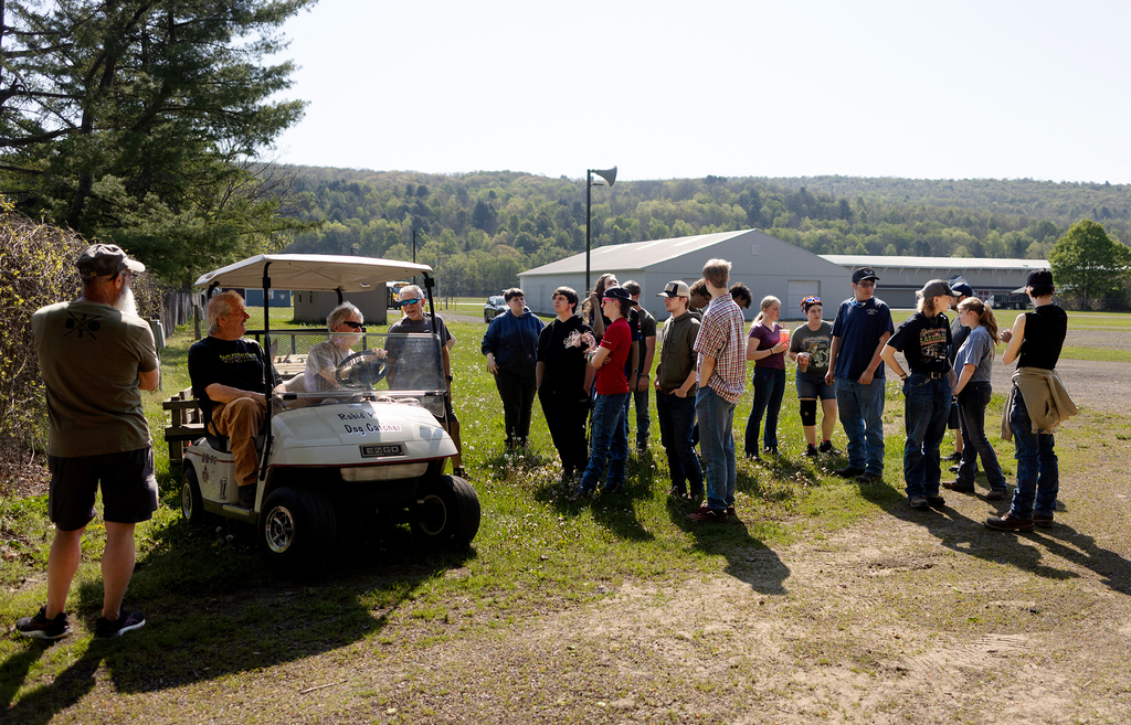 Auto tech students getting instructions from car club leaders