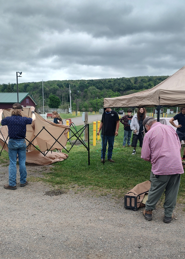 auto tech students and instructors setting up shelters