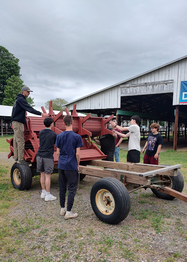 auto tech students unloading picnic tables from a trailer
