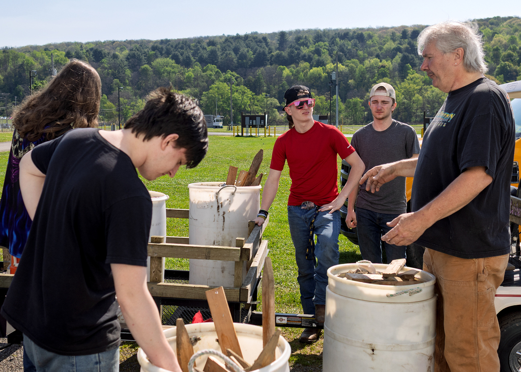 car club leader instructing auto tech students