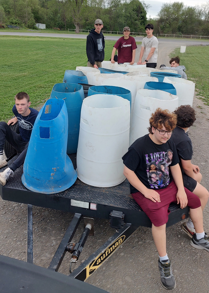 auto tech students with a trailer full of garbage cans