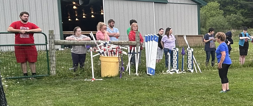 students listen as a canine business owner tells them about her business