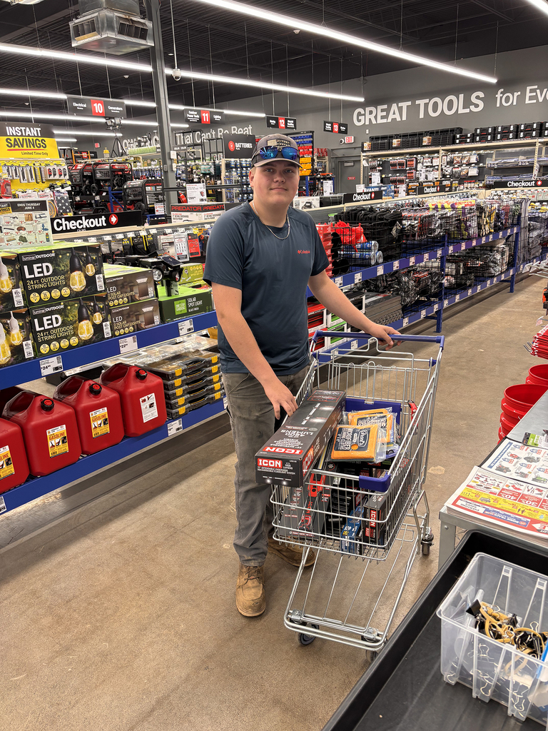 Jackson Barker in an auto supply store with a cart full of items he is purchasing with his scholarship money.