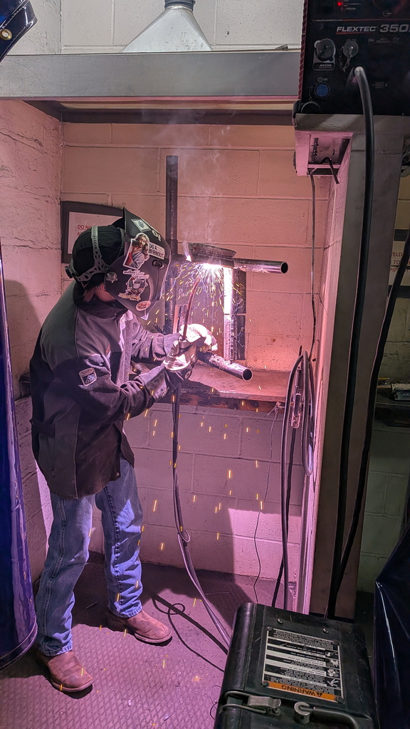 A student welding at the training center