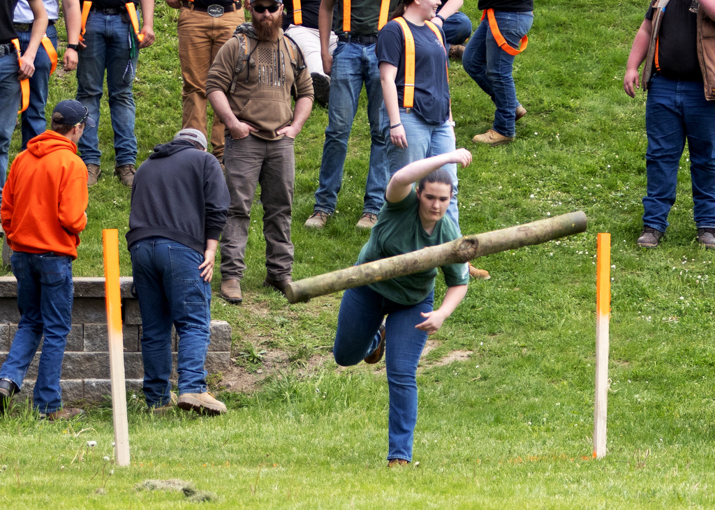 student throwing a small log