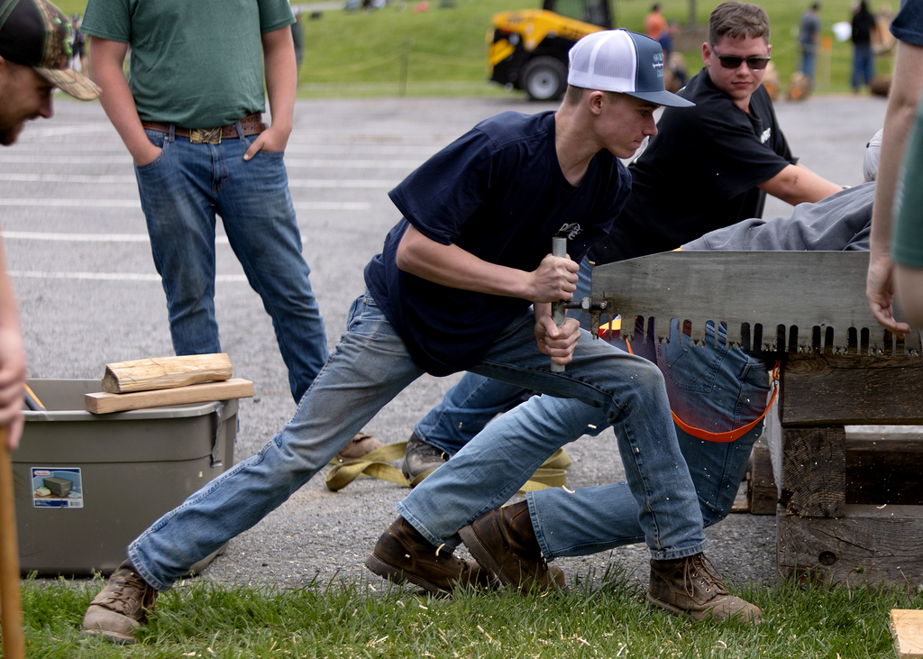 student sawing with a 2-man crosscut saw