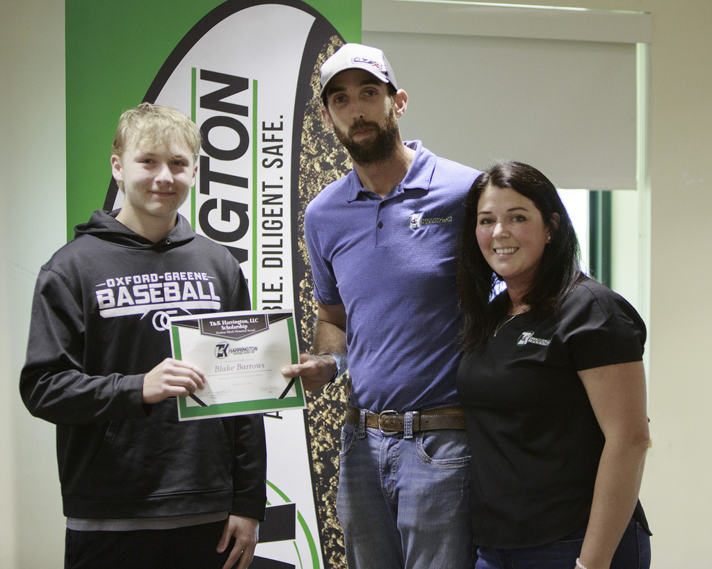 Blake Barrows receives a certificate from two representatives of T & K Harrington