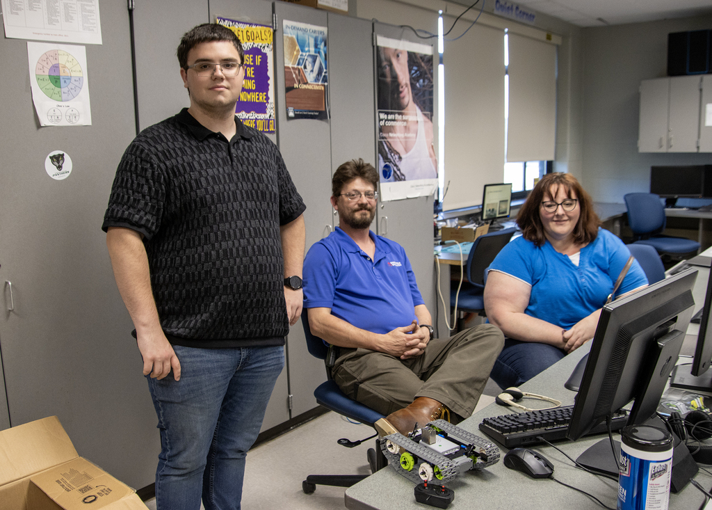 student with his robot and parents