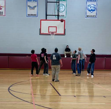 students playing basketball in the gym