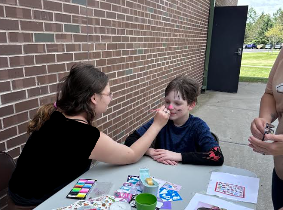 student getting face painted