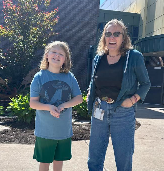 student and adult smiling in the sun