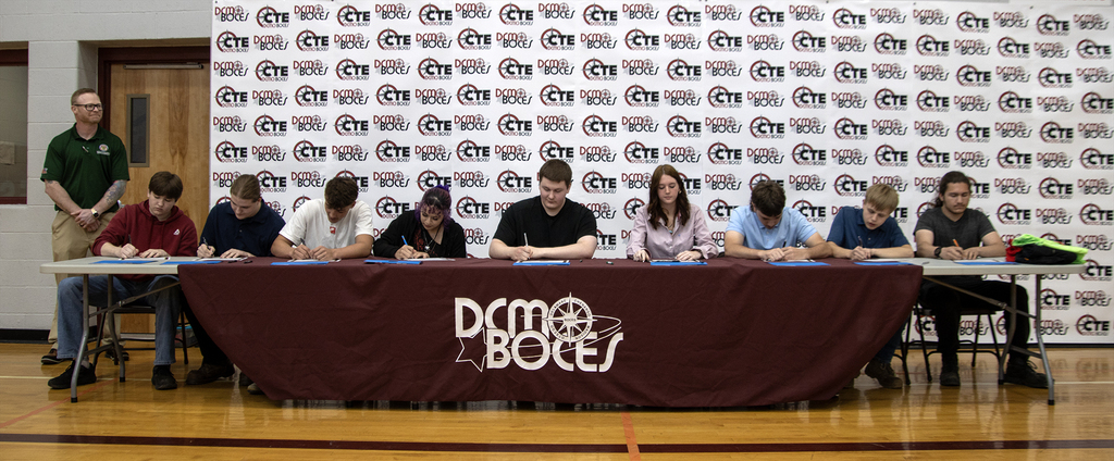 students signing their commitment letters