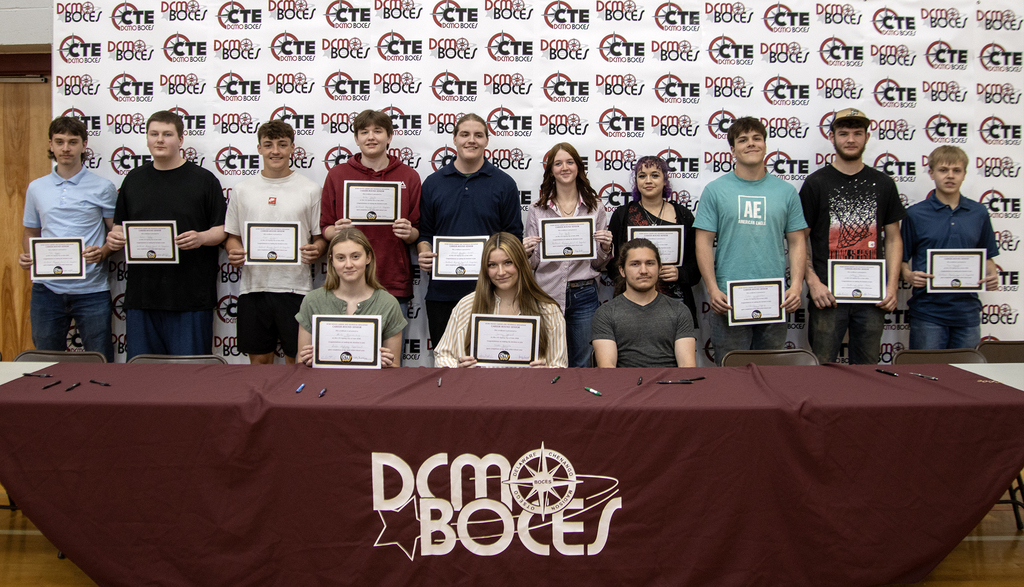 students pose with their commitment ceertificates