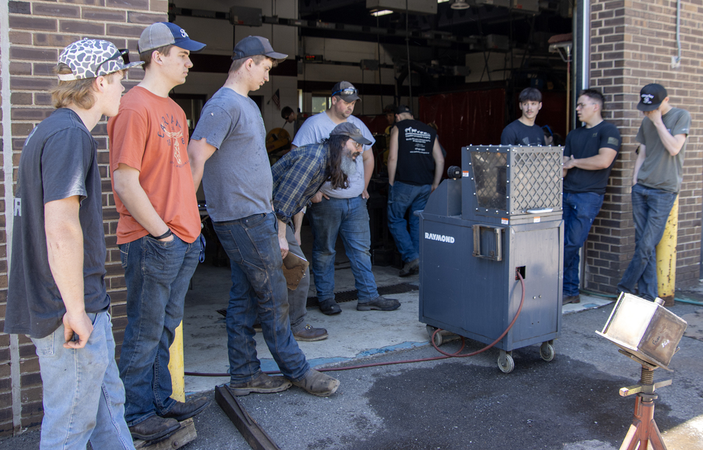 Students and teachers gathered around the pressure test machine