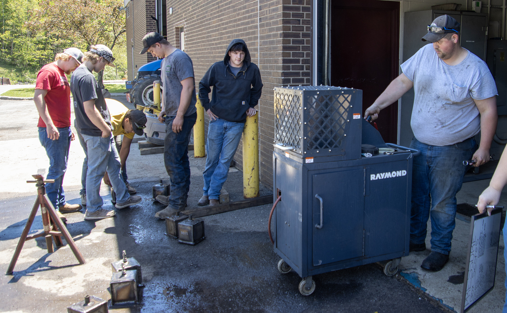 Students and teachers gathered around the pressure test machine