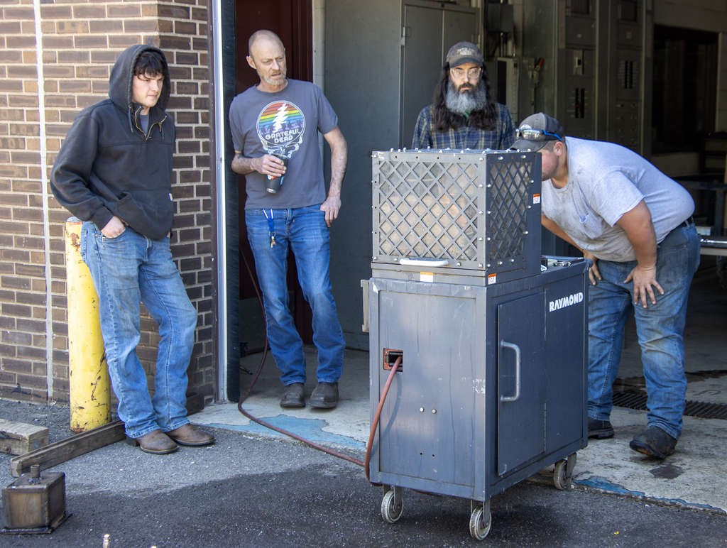 Students and teachers gathered around the pressure test machine