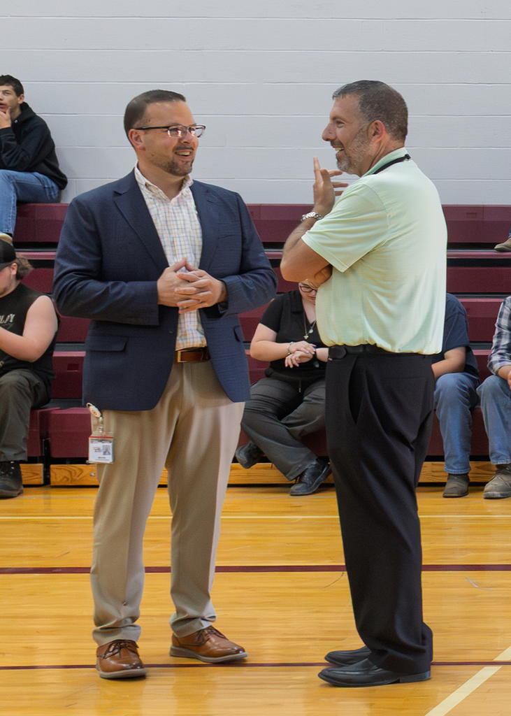 Mike Rullo talks with a school administrator