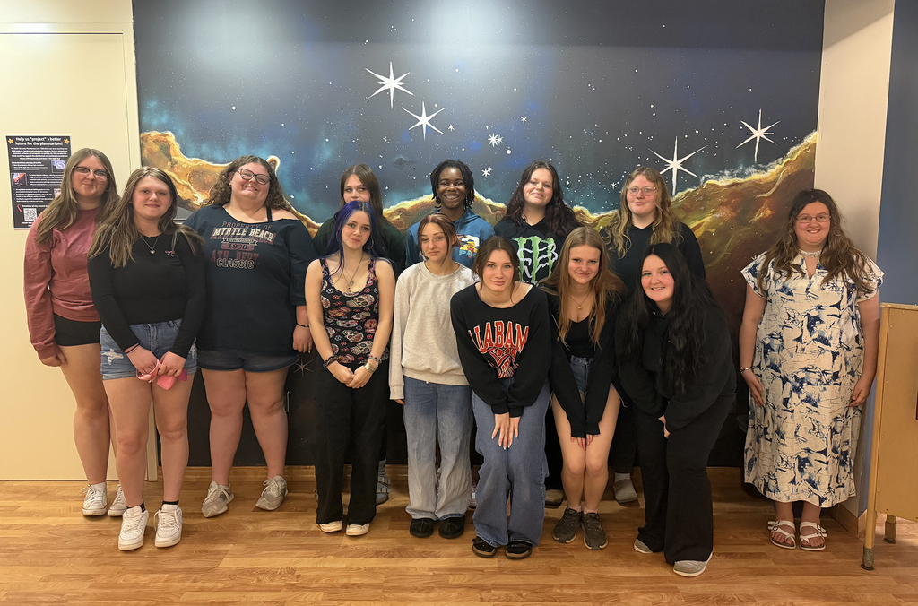 students pose in a group at the planetarium