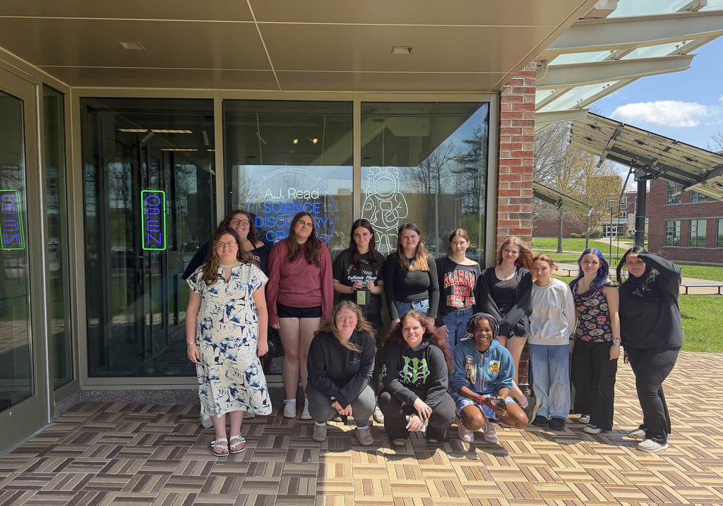 students pose in a group at the science discovery center