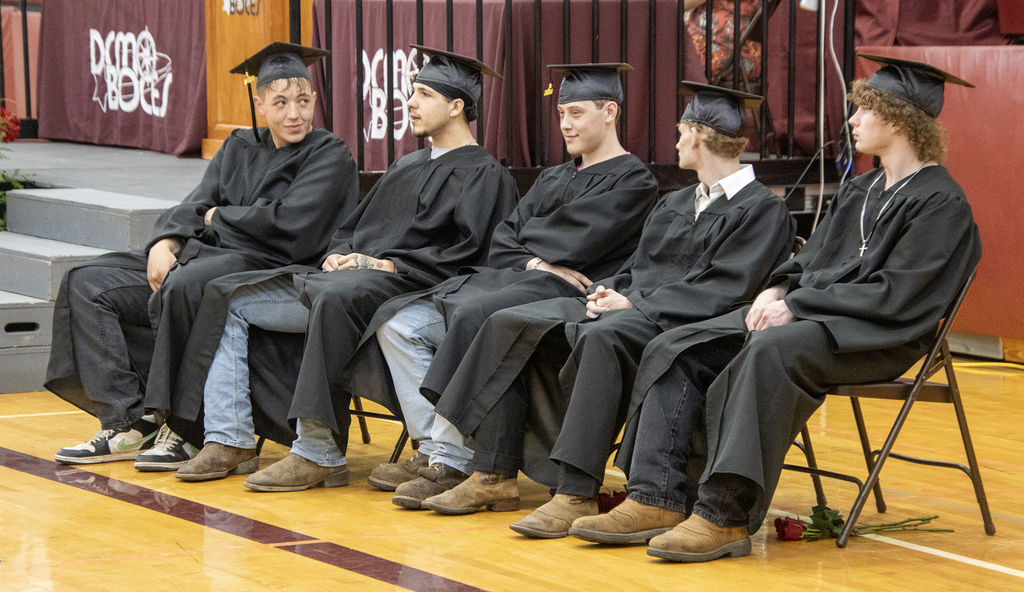 seniors sitting in caps and gowns