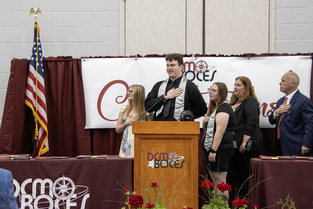 students lead the audience in the pledge of allegience
