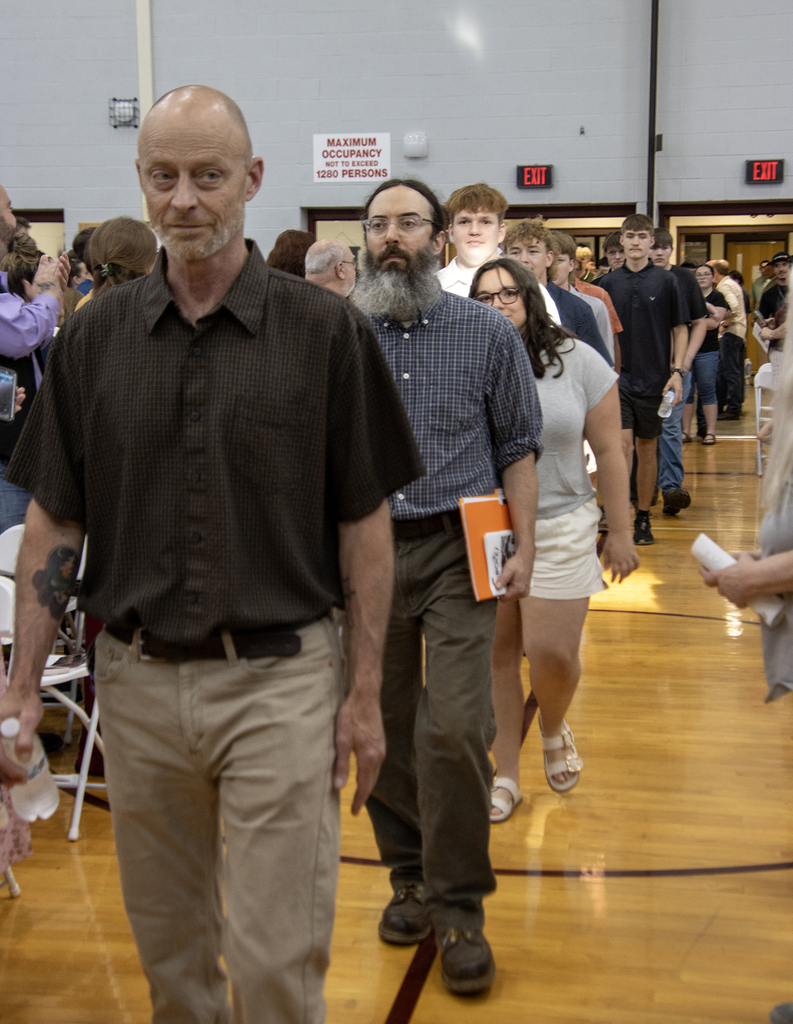 Teachers leading students in a processional
