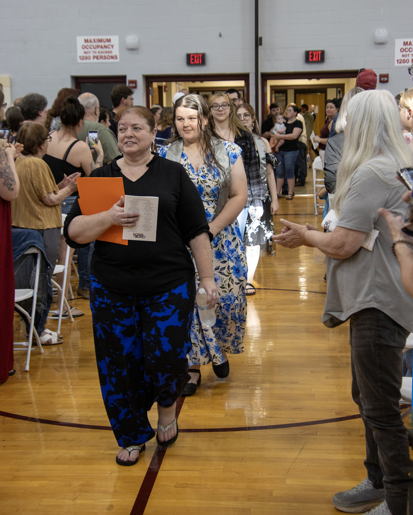 Teacher leading students in a processional