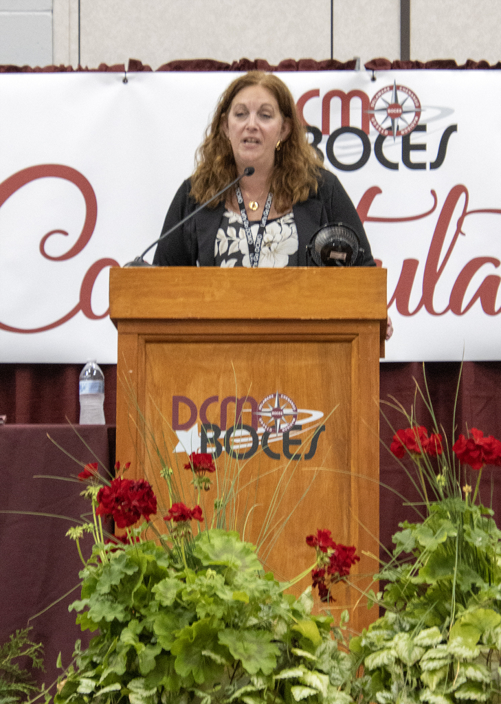 principal speaking from lectern