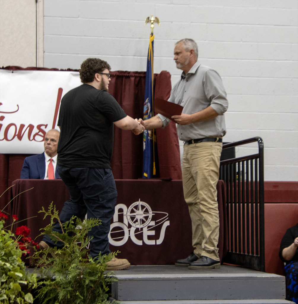 student handshake with auto body teacher